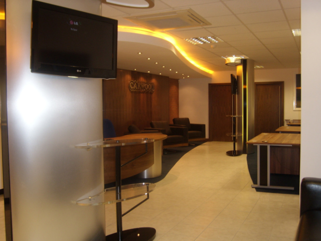 Office fit out in Birmingham featuring a modern reception area with warm ambient lighting.